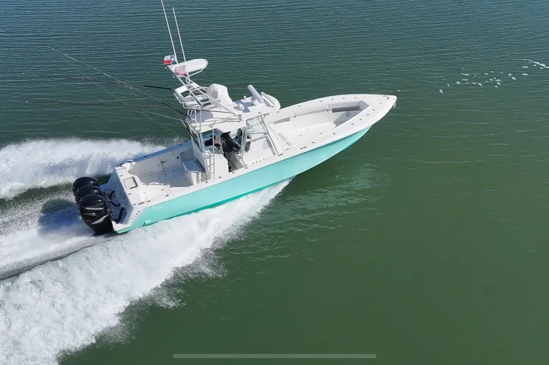 Uno Mas Yacht Photos Pics 2013 SeaVee 39B Center Console boat cruising on open water.