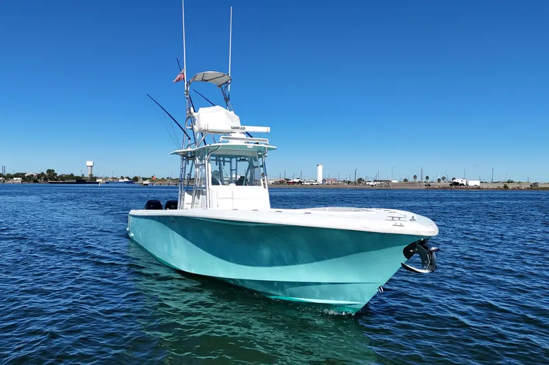 Uno Mas Yacht Photos Pics 2013 SeaVee 39B Center Console boat on calm water, clear blue sky.