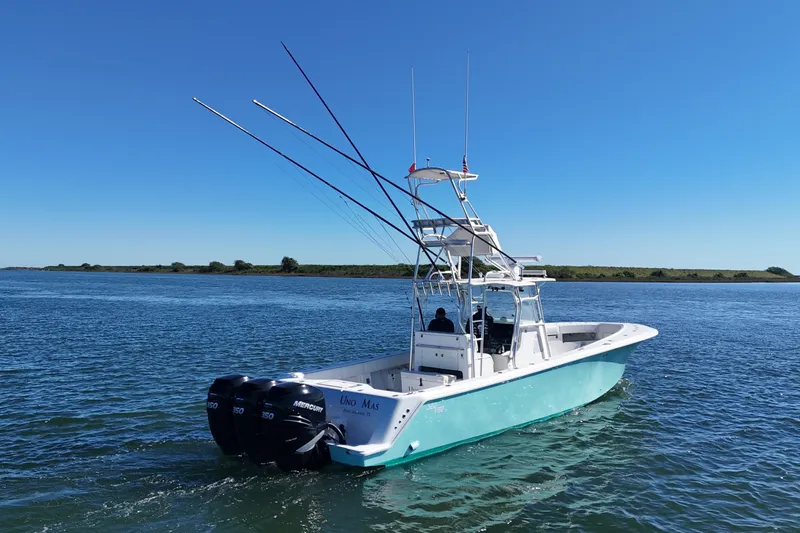 Uno Mas Yacht Photos Pics 2013 SeaVee 39B Center Console boat on calm water with clear blue sky.