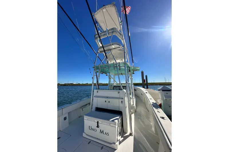 Uno Mas Yacht Photos Pics 2013 SeaVee 39B Center Console boat with tower, docked under clear blue sky.