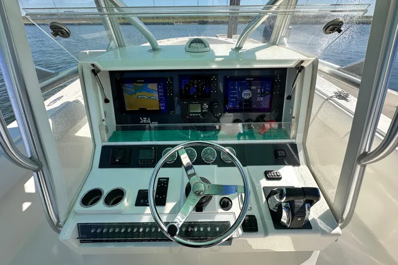 Uno Mas Yacht Photos Pics 2013 SeaVee 39B Center Console helm with advanced navigation displays and controls.