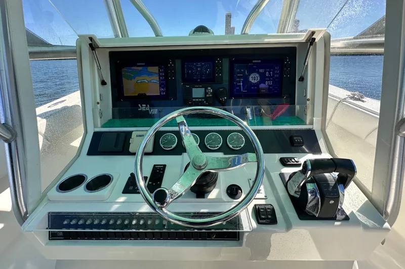 Uno Mas Yacht Photos Pics 2013 SeaVee 39B Center Console helm with navigation screens and controls.