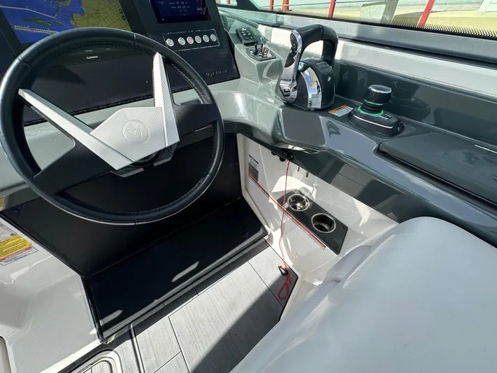  Yacht Photos Pics 2022 Aviara AV 32 OB boat cockpit with steering wheel and control panel.