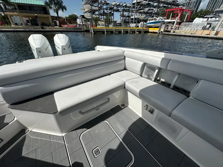  Yacht Photos Pics 2022 Aviara AV 32 OB boat interior with gray seating and dual Mercury outboard engines.