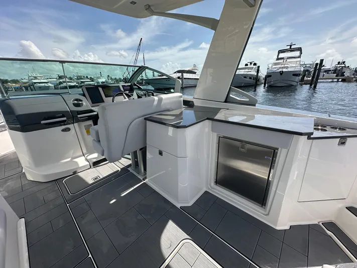  Yacht Photos Pics 2022 Aviara AV 32 OB boat interior with sleek design, modern helm, and waterfront view.