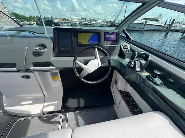  Yacht Photos Pics 2022 Aviara AV 32 OB helm with modern controls and navigation screens at marina.