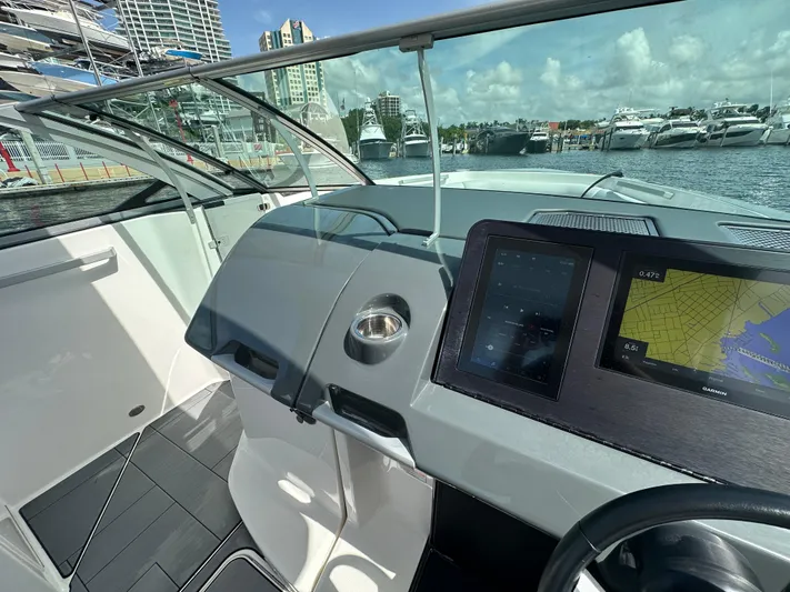  Yacht Photos Pics Helm of 2022 Aviara AV 32 OB boat with navigation screens and marina view.