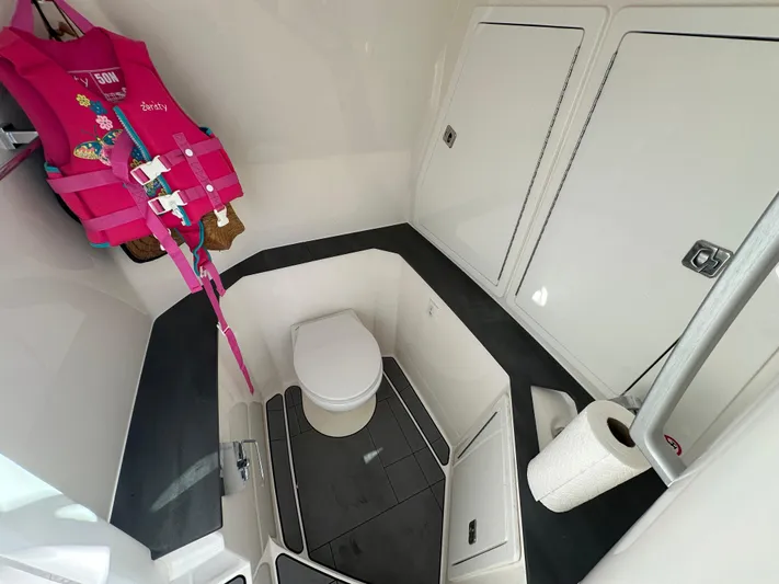  Yacht Photos Pics 2022 Aviara AV 32 OB boat interior with toilet, storage, and life jacket.