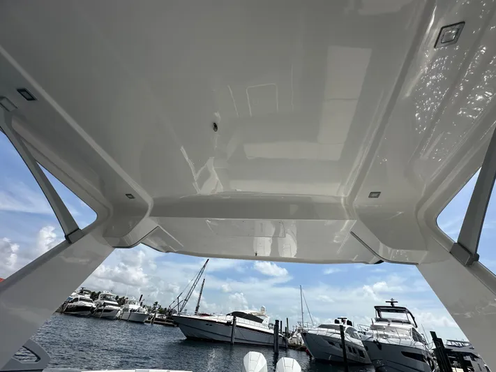  Yacht Photos Pics 2022 Aviara AV 32 OB boat canopy with marina view in the background.