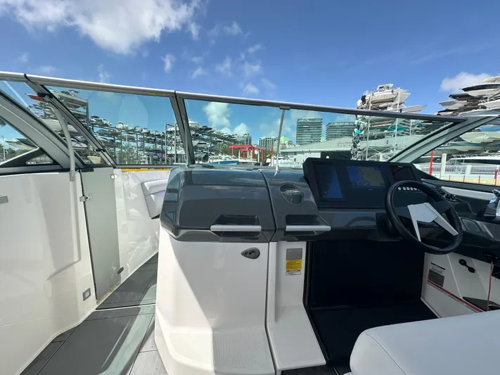  Yacht Photos Pics 2022 Aviara AV 32 OB boat cockpit with modern dashboard and steering wheel.