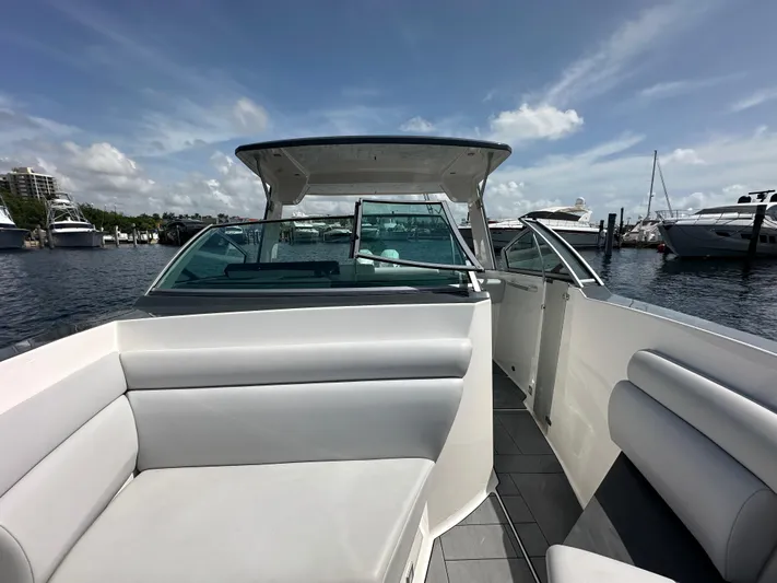  Yacht Photos Pics 2022 Aviara AV 32 OB boat interior with seating, docked at marina under blue sky.
