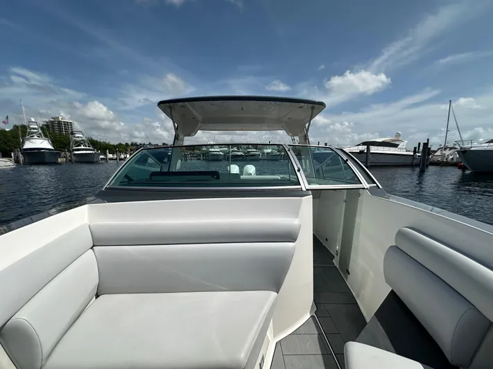 Yacht Photos Pics 2022 Aviara AV 32 OB boat interior with seating, docked at marina under blue sky.