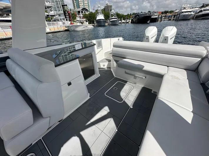  Yacht Photos Pics 2022 Aviara AV 32 OB boat interior with sleek seating and modern design at a marina.