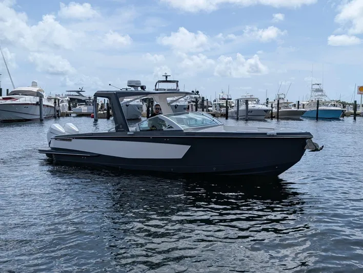  Yacht Photos Pics 2022 Aviara AV 32 OB boat docked in a marina under a partly cloudy sky.