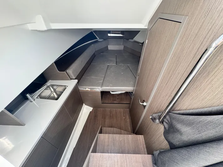  Yacht Photos Pics 2024 Beneteau Flyer 9 SUNdeck interior with kitchenette and seating area.