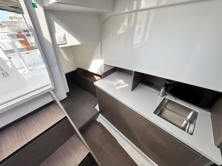  Yacht Photos Pics 2024 Beneteau Flyer 9 SUNdeck interior with modern kitchenette and sleek design.