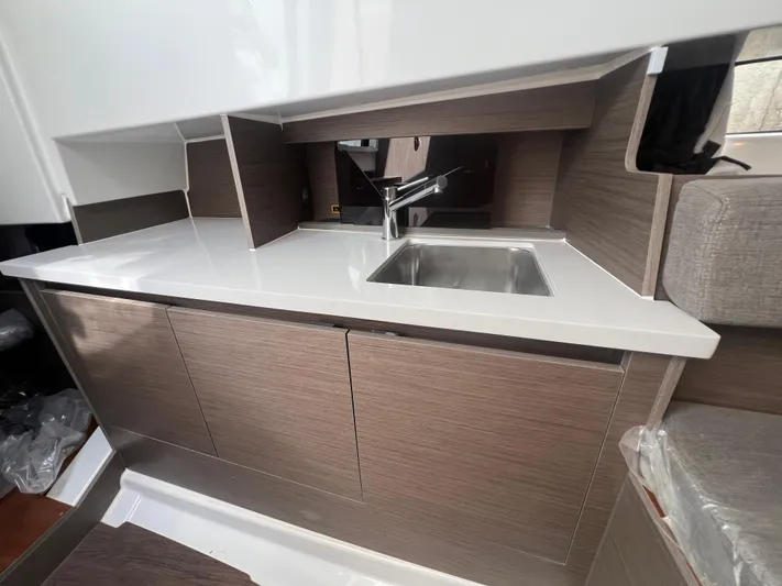 Yacht Photos Pics 2025 Beneteau Flyer 9 SUNdeck interior kitchen with modern sink and cabinetry.