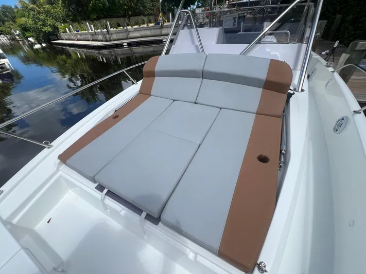  Yacht Photos Pics 2025 Beneteau Flyer 9 SUNdeck with spacious sunbathing area, docked by a serene waterfront.