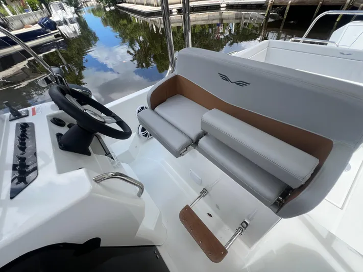  Yacht Photos Pics 2025 Beneteau Flyer 9 SUNdeck cockpit with steering wheel and cushioned seating.