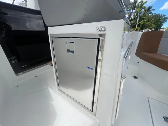  Yacht Photos Pics 2025 Beneteau Flyer 9 SUNdeck interior with stainless steel cabinet and seating.