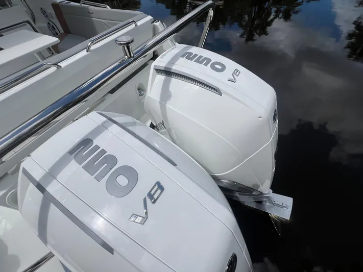  Yacht Photos Pics 2025 Beneteau Flyer 9 SUNdeck with dual outboard engines on calm water.