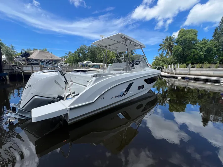  Yacht Photos Pics 2025 Beneteau Flyer 9 SUNdeck boat docked on a sunny day, reflecting in calm water.