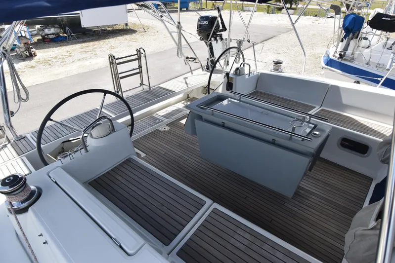 Drift Yacht Photos Pics Cockpit of 2015 Beneteau Oceanis 45 sailboat with dual steering wheels and teak flooring.