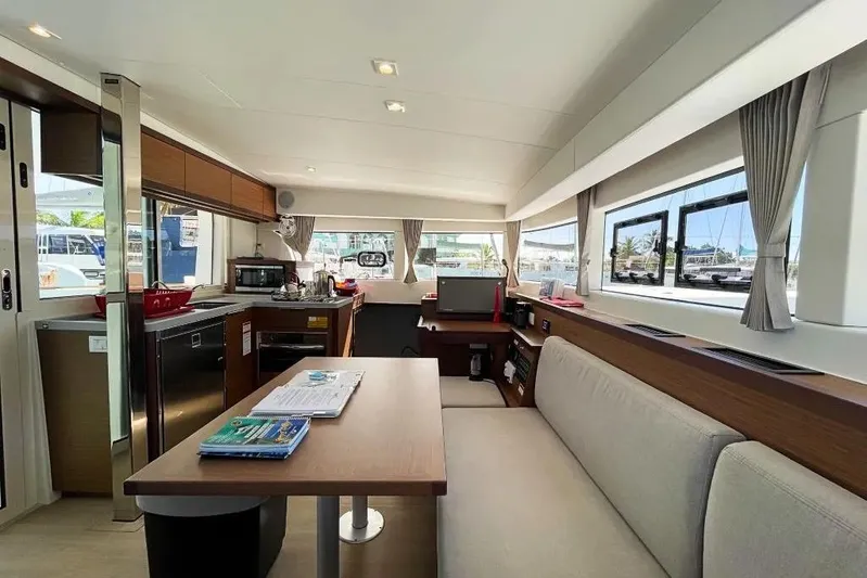 Noble Shadow Yacht Photos Pics Interior of 2022 Lagoon 40 catamaran with modern kitchen and seating area.