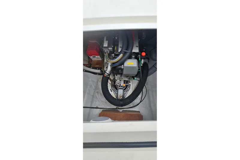 Noble Shadow Yacht Photos Pics Engine compartment of a 2022 Lagoon 40 catamaran, showcasing mechanical components and wiring.