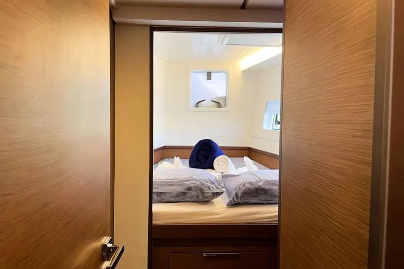 Noble Shadow Yacht Photos Pics Interior cabin of 2022 Lagoon 40 yacht with neatly arranged bedding.