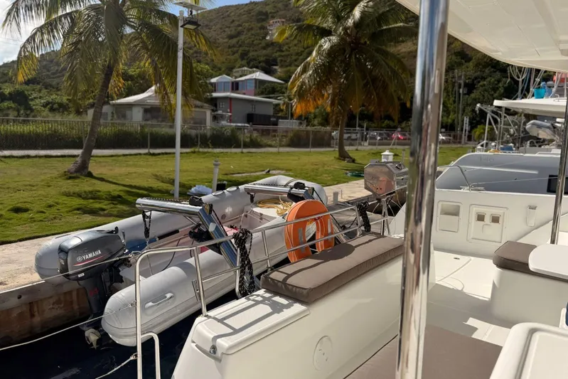 Noble Shadow Yacht Photos Pics Lagoon 40 catamaran docked, featuring Yamaha motor and lush tropical surroundings, 2022 model.