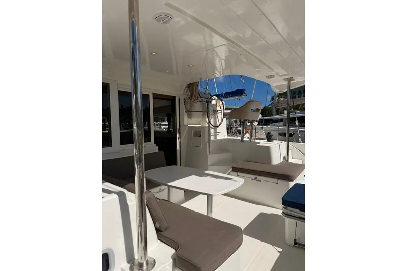 Noble Shadow Yacht Photos Pics 2022 Lagoon 40 yacht interior with seating and table, showcasing modern design.