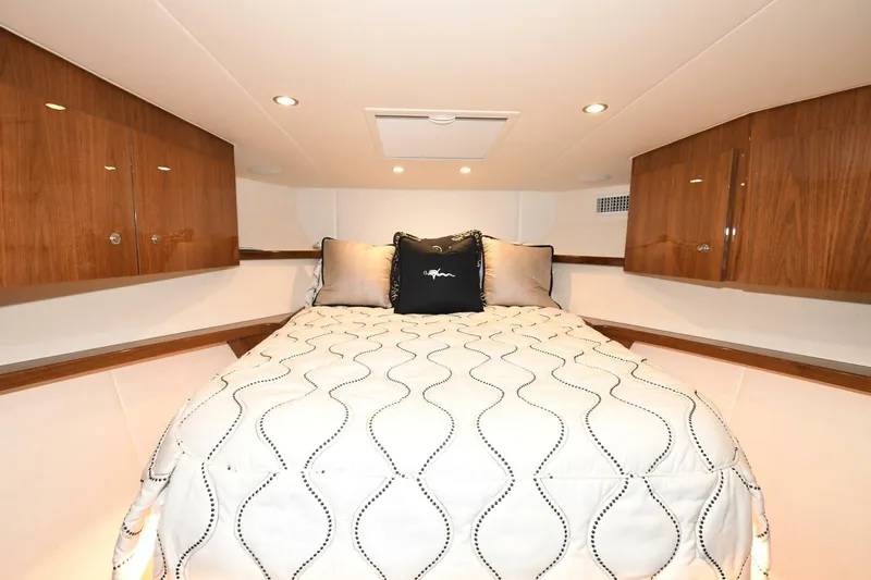 Galati Yacht Sales Trade Yacht Photos Pics Luxurious bedroom interior of 2022 Viking 44 Sport Coupe yacht with elegant bedding.
