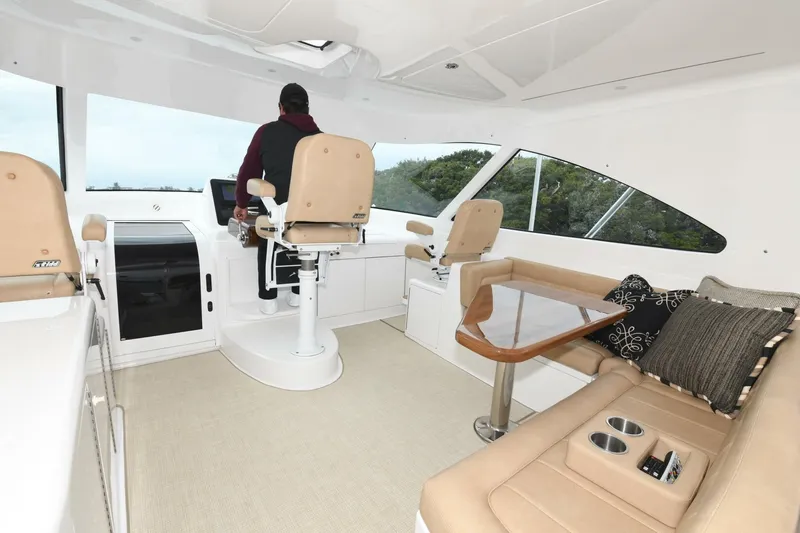 Galati Yacht Sales Trade Yacht Photos Pics 2022 Viking 44 Sport Coupe interior with helm, seating, and table.