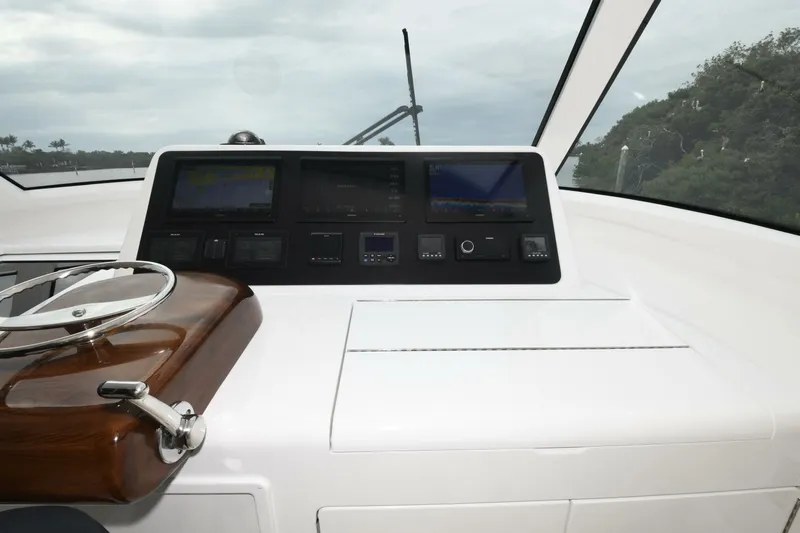 Galati Yacht Sales Trade Yacht Photos Pics 2022 Viking 44 Sport Coupe dashboard with modern navigation controls and steering wheel.