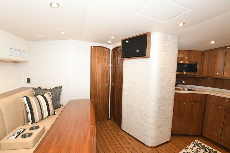 Galati Yacht Sales Trade Yacht Photos Pics Interior of 2022 Viking 44 Sport Coupe yacht with modern wood finishes and cozy seating.