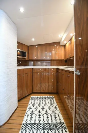 Galati Yacht Sales Trade Yacht Photos Pics Luxurious interior of 2022 Viking 44 Sport Coupe yacht with sleek wood cabinetry and modern design.