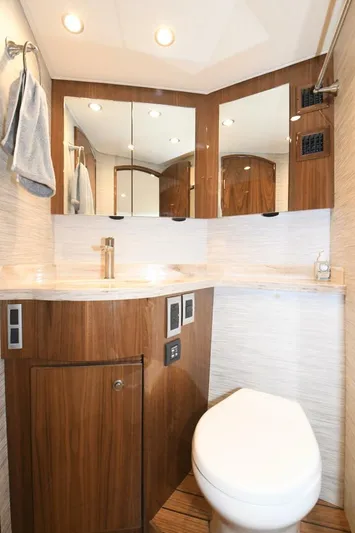 Galati Yacht Sales Trade Yacht Photos Pics 2022 Viking 44 Sport Coupe bathroom with modern fixtures and wood accents.