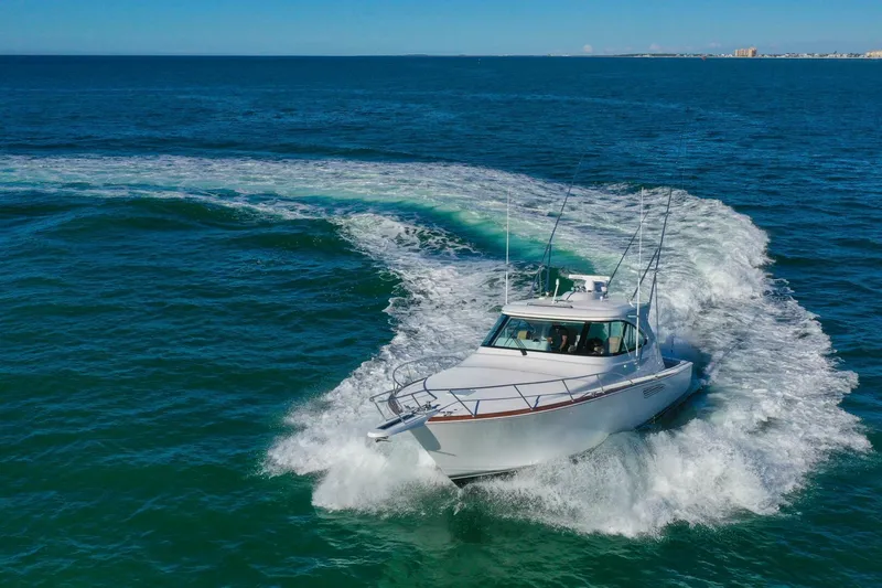 Galati Yacht Sales Trade Yacht Photos Pics 2022 Viking 44 Sport Coupe cruising on open water, creating a dynamic wake.