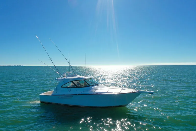 Galati Yacht Sales Trade Yacht Photos Pics 2022 Viking 44 Sport Coupe yacht cruising on sunny ocean waters.