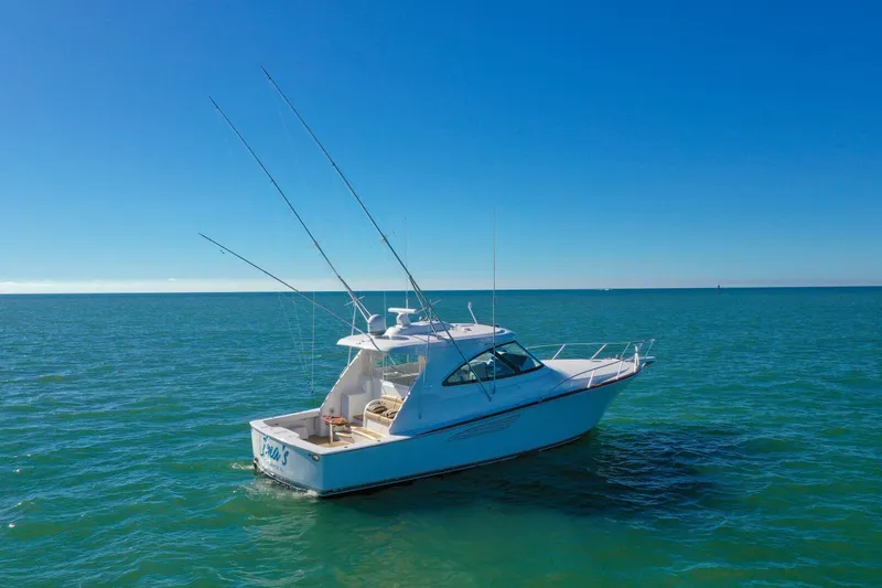 Galati Yacht Sales Trade Yacht Photos Pics 2022 Viking 44 Sport Coupe yacht cruising on open sea under clear blue sky.