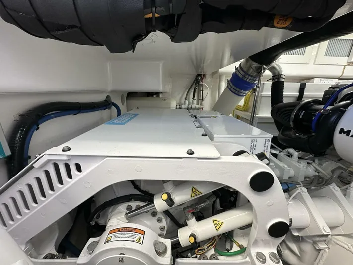 Galati Yacht Sales Trade Yacht Photos Pics Engine room of 2022 Viking 44 Sport Coupe, showcasing mechanical components and piping.