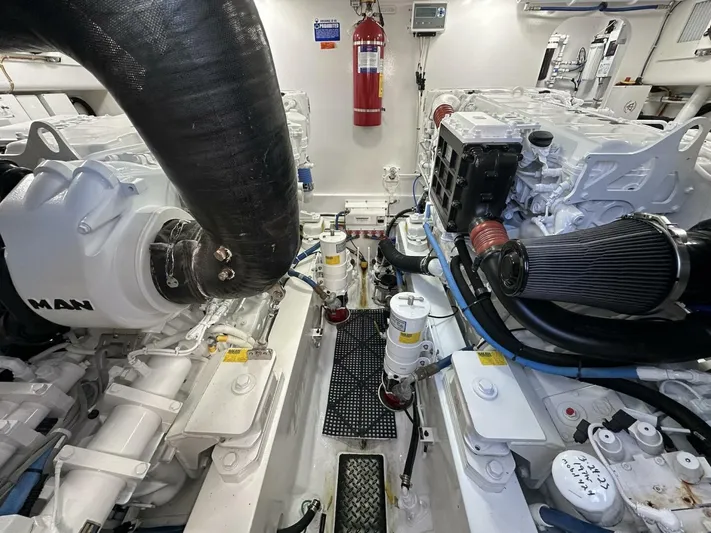 Galati Yacht Sales Trade Yacht Photos Pics Engine room of a 2022 Viking 44 Sport Coupe, showcasing dual engines and equipment.