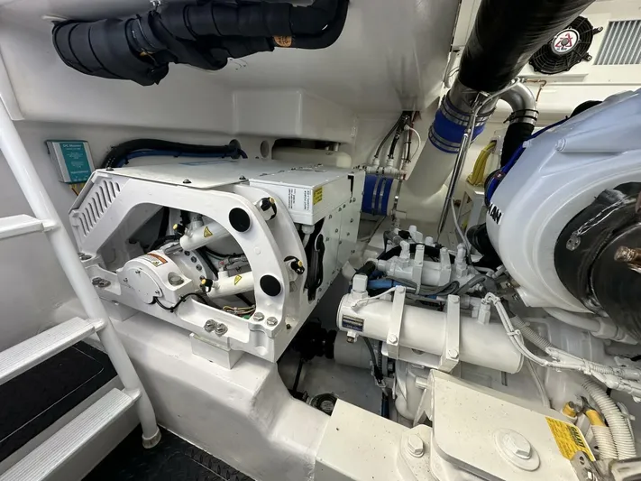 Galati Yacht Sales Trade Yacht Photos Pics Engine room of 2022 Viking 44 Sport Coupe, showcasing mechanical components and piping.
