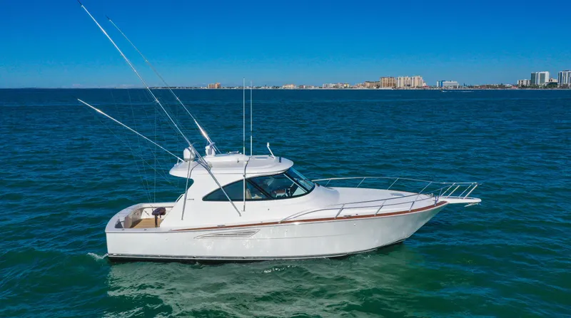 Galati Yacht Sales Trade Yacht Photos Pics 2022 Viking 44 Sport Coupe yacht cruising on open water under clear blue skies.