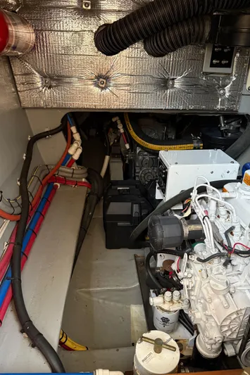 Jammy Yacht Photos Pics Engine room of a 2015 Gunboat 57' yacht, showcasing mechanical components and wiring.