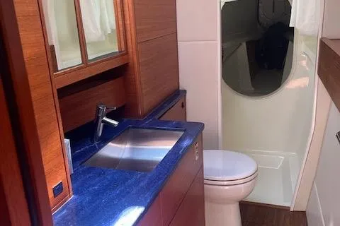 Jammy Yacht Photos Pics Luxurious bathroom in a 2015 Gunboat 57' yacht with modern fixtures and wood accents.