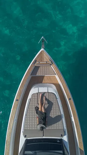 Pardo 43 Yacht Photos Pics 2024 Pardo Yachts 43, aerial view, person relaxing on deck, turquoise water background.