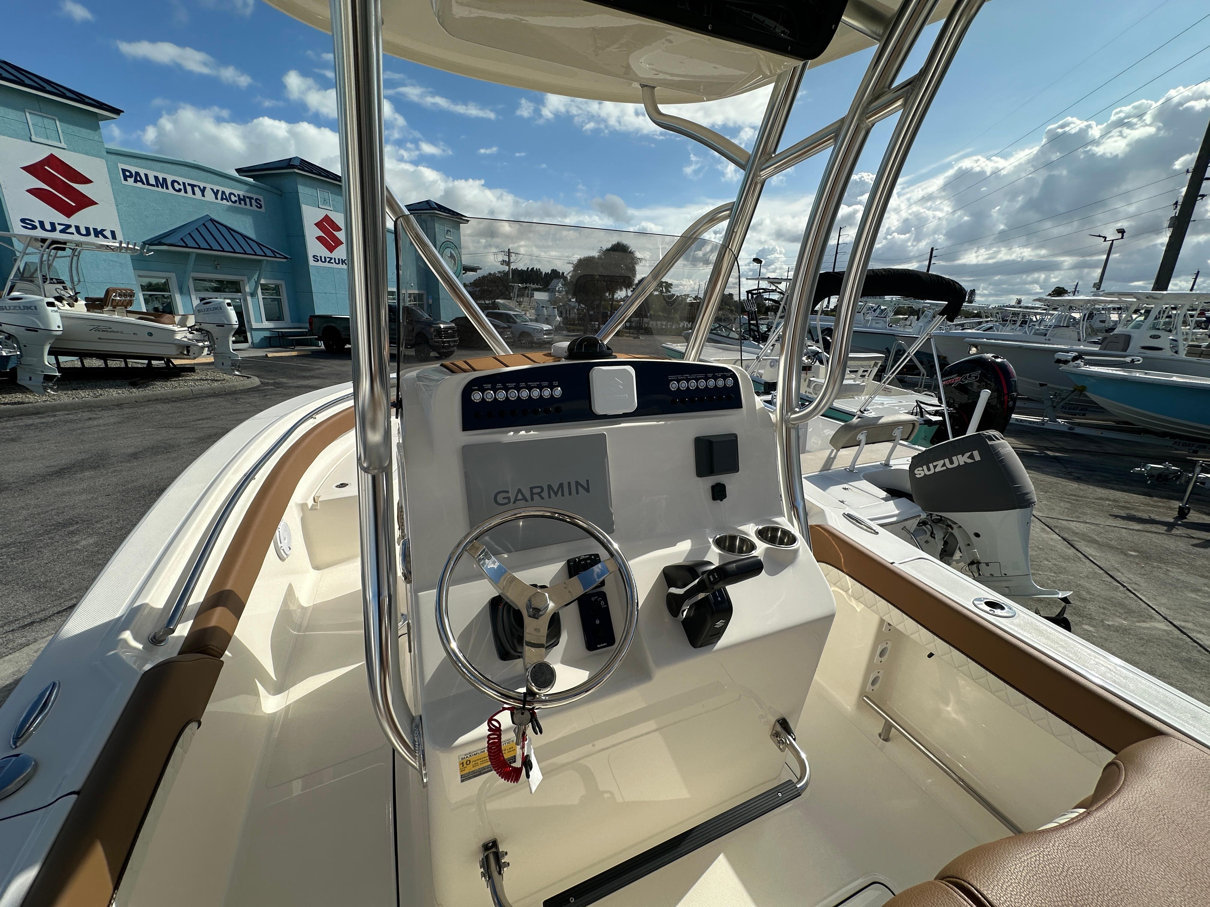 2025 Pioneer 222 Sportfish boat dashboard with Garmin system at Palm City Yachts.