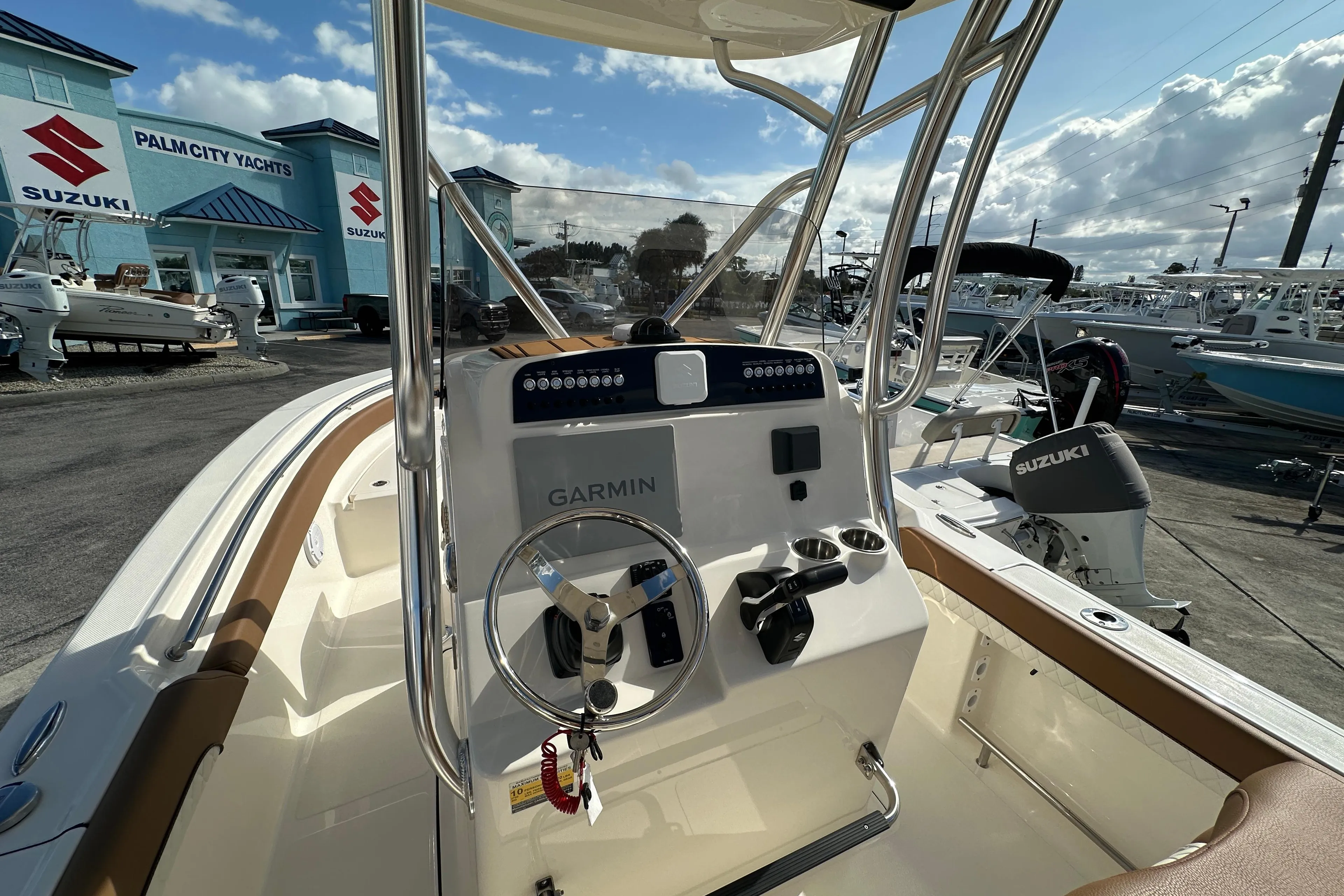 2025 Pioneer 222 Sportfish boat dashboard with Garmin system at Palm City Yachts.